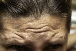forehead of mature caucasian man in close up view, face wrinkles concepts